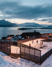 Children playing football in the village of Nes, Faroe Islands.